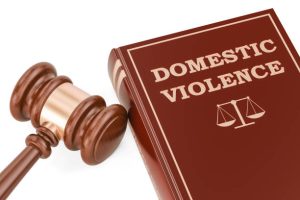Domestic violence concept with gavel and book, 3D rendering